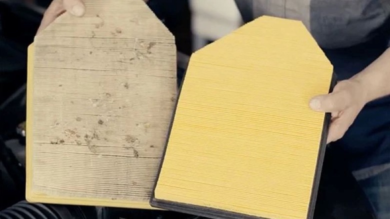 person comparing clean and dirty air filters