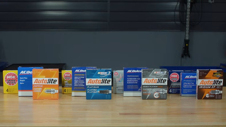 A variety of spark plug boxes on a table