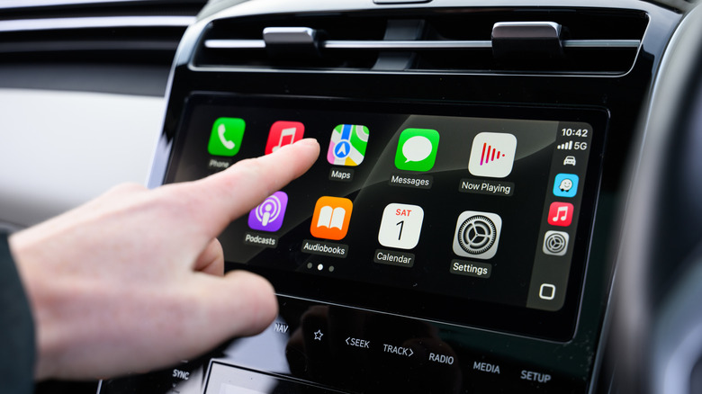Finger pointing at CarPlay Maps application