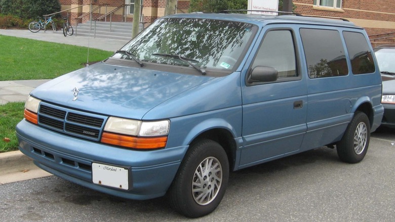 A '90s Dodge Caravan parked on the side of the road