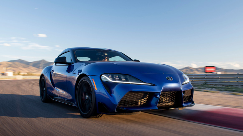 2026 Toyota GR Supra driving on racetrack, front right 3/4 view
