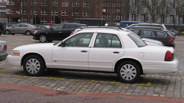 White Ford Crown Victoria outside in a parking lot