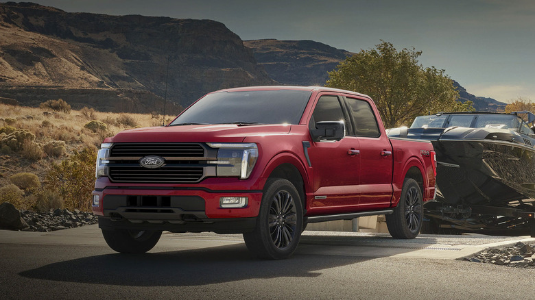 A red 2025 Ford F-150 towing a boat