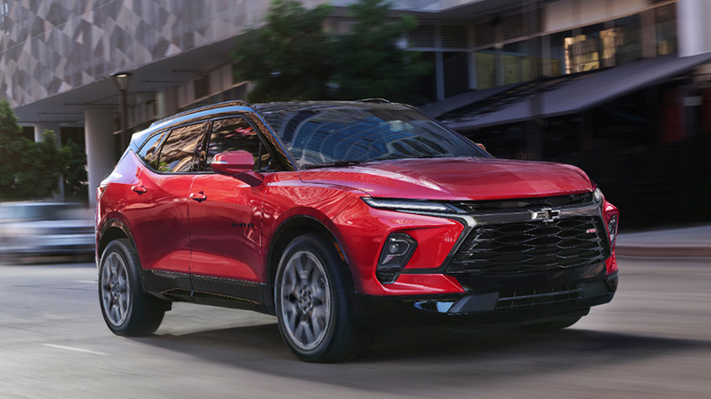 2026 Chevrolet Blazer driving in urban landscape, front-right 3/4 view