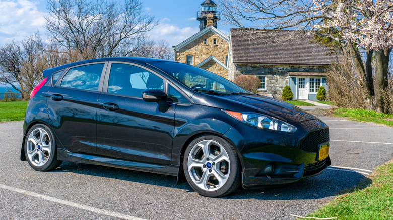 Front 3/4 view of black Ford Fiesta ST parked in parking lot.