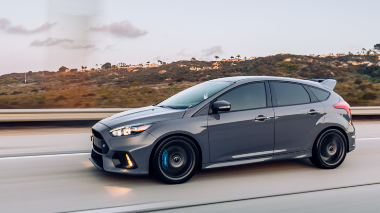 Side view of gray Ford Focus RS driving on highway.