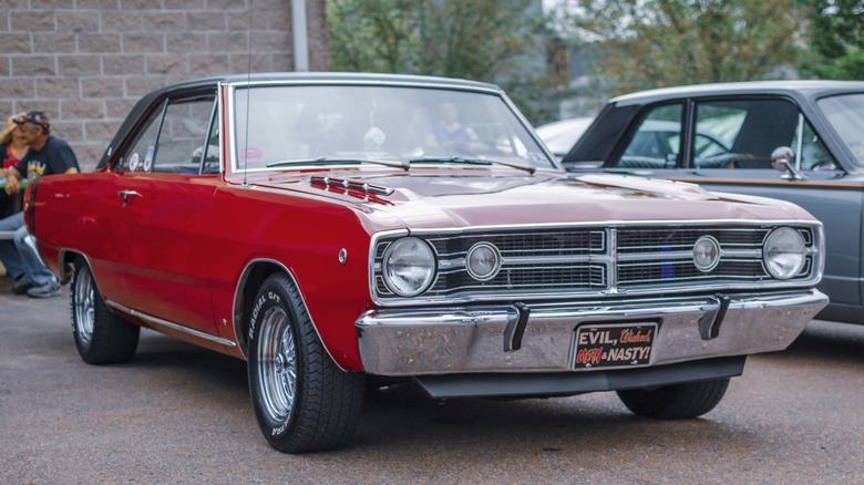 a red 1968 Dodge Dart at a car show
