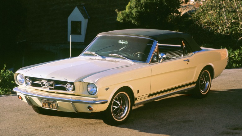 a white 1965 Ford Mustang basking in the sunset glow