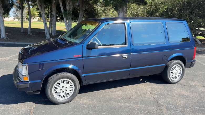 1983 Dodge Caravan in blue on a parking lot, front-left 3/4 view