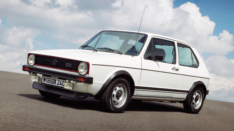 1983 Volkswagen Golf GTI with clouds in background, front-left 3/4 view