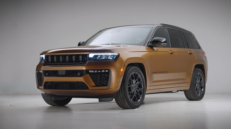 Front 3/left view of gold 2026 Jeep Grand Cherokee in studio