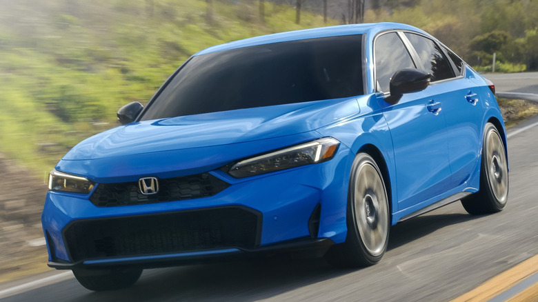 Front 3/4 view of Honda Civic on winding mountain road