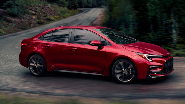 Front 3/4 view of 2026 Toyota Corolla on curvy mountain road
