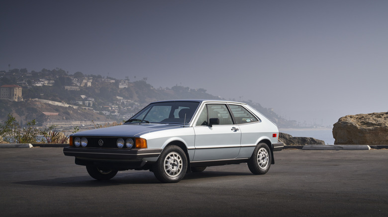 Silver 1981 Volkswagen Scirocco seen from left front parked on an overlook