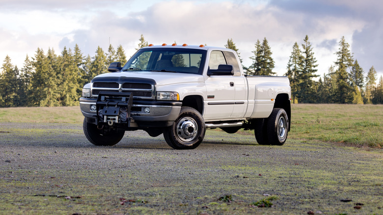 A white Dodge Ram 3500 parked in nature