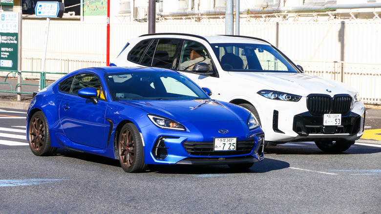 A blue Subaru BRZ in traffic