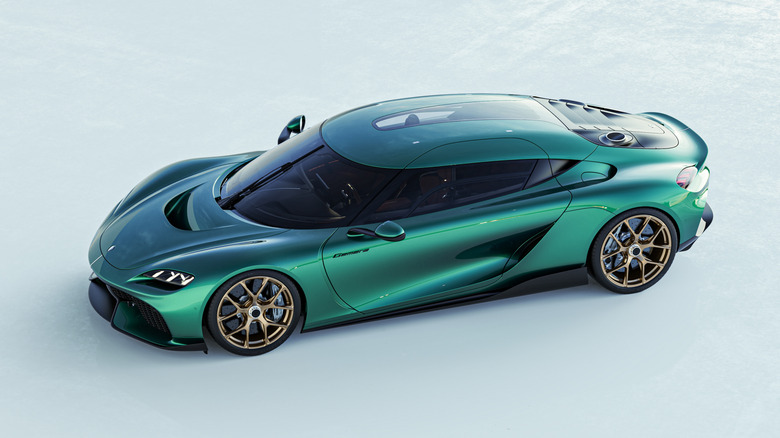 Koenigsegg Gemera in green with gold wheels, side view, high angle
