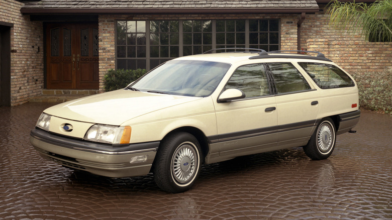 1986 Ford Taurus wagon parked in front of house, front-left 3/4 view