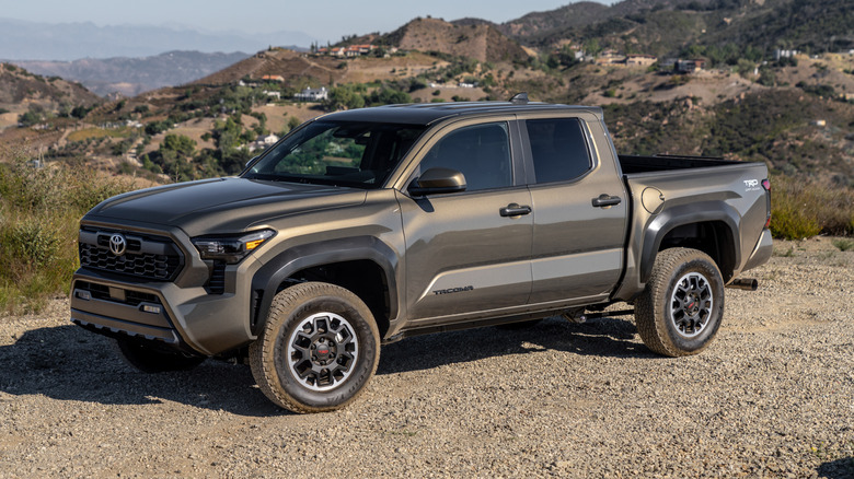 2026 Toyota Tacoma TRD Off-Road parked in desert terrain, front-left 3/4 view
