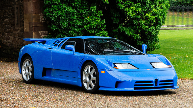 1992 Bugatti EB 110 parked in country home driveway, front-right 3/4 view