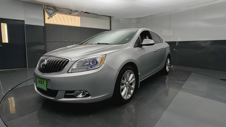Silver 2014 Buick Verano at a dealership, front 3/4 view