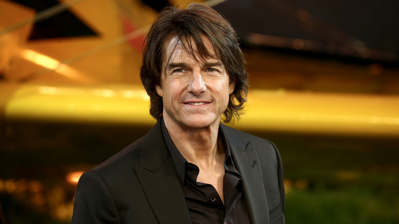Tom Cruise smiles for photographer.
