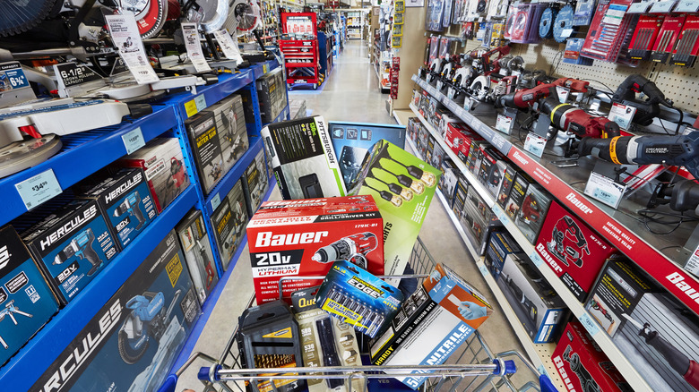A cart full of tools being pushed through a Harbor Freight store.