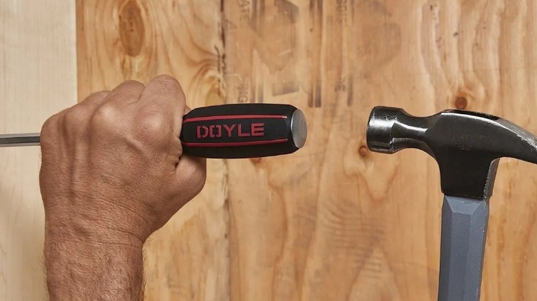 Person hammering a Doyle Heavy Duty Screwdriver Set