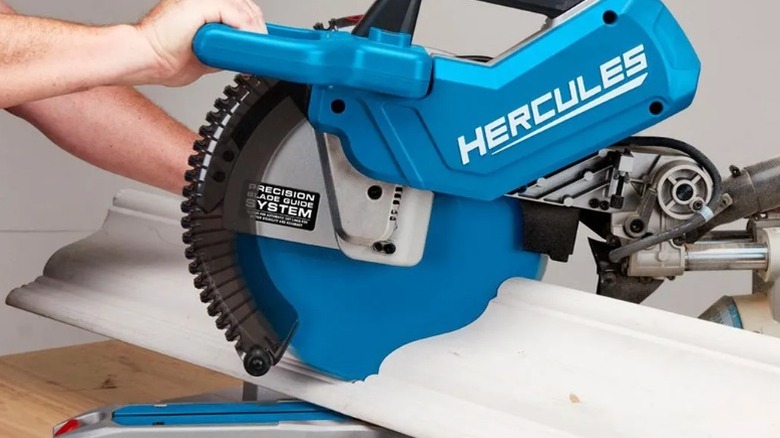 Person cutting crown molding with a Hercules 12-inch Dual-Bevel Sliding Compound Miter Saw