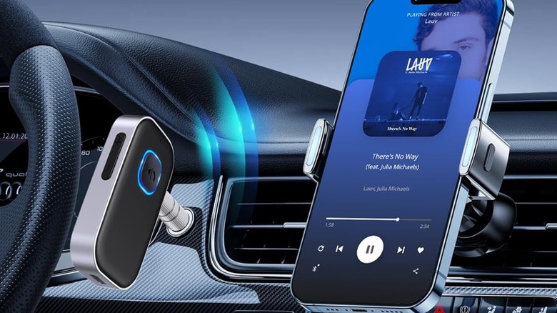 bluetooth receiver on car dashboard next to a mobile phone playing music