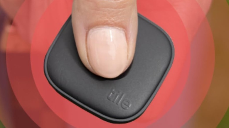 person pressing SOS button on Tile