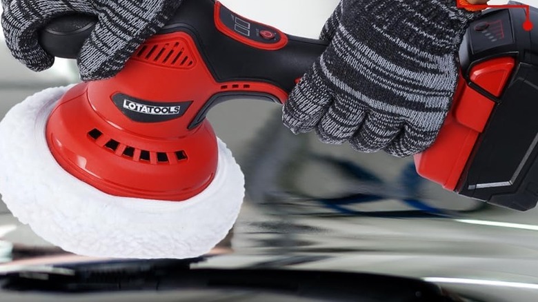 A person uses a LotaTools Cordless Car Polisher.