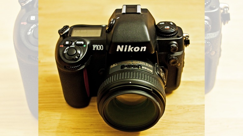 a Nikon F100 camera on a desk