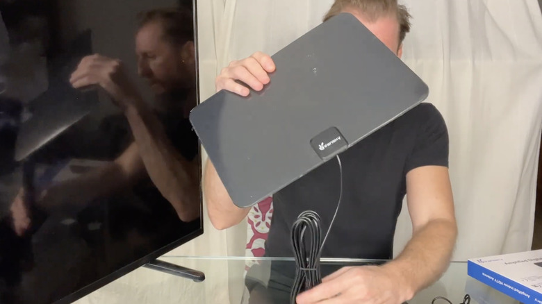 man holding tv antenna