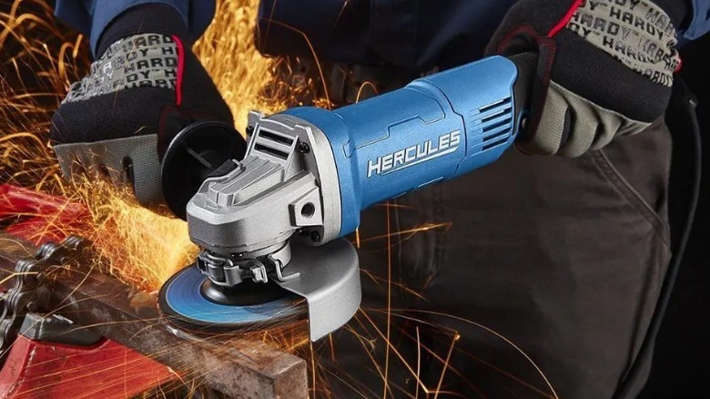 Person using Hercules 13 Amp 4 ½-inch to 6-inch Trigger-Grip Angle Grinder on steel