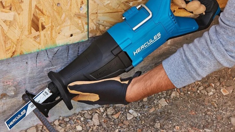 Person cutting pipe with Hercules 12 Amp Variable-Speed Reciprocating Saw