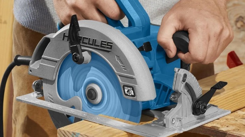 Person cutting board with Hercules 15 Amp 7 ¼-inch Circular Saw