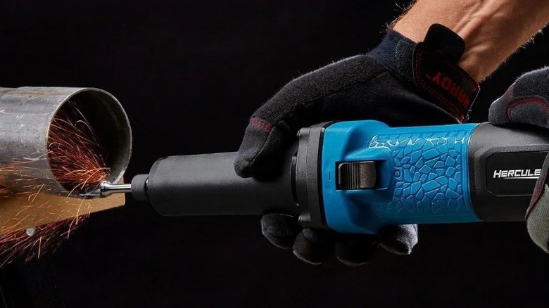 Person smoothing pipe with Hercules 4 Amp ¼-inch Die Grinder
