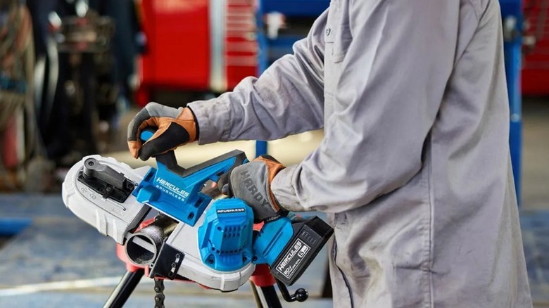 Person cutting pipe with Hercules 20V 2 ½-inch Variable-Speed Compact Band Saw