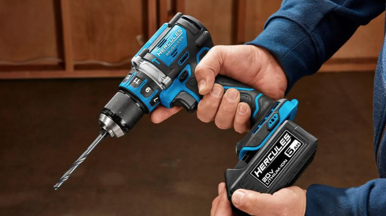 Hercules hammer drill/driver in man's hand with battery attached