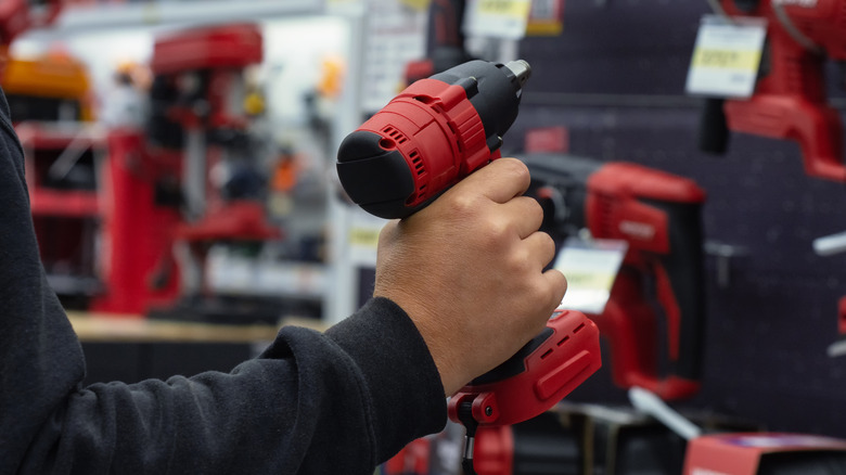 Man holding red power tool