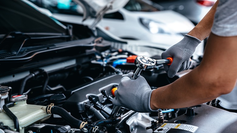 Mechanic changing spark plugs