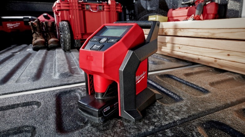 Milwaukee M12 Compact Inflator sitting on truck bed