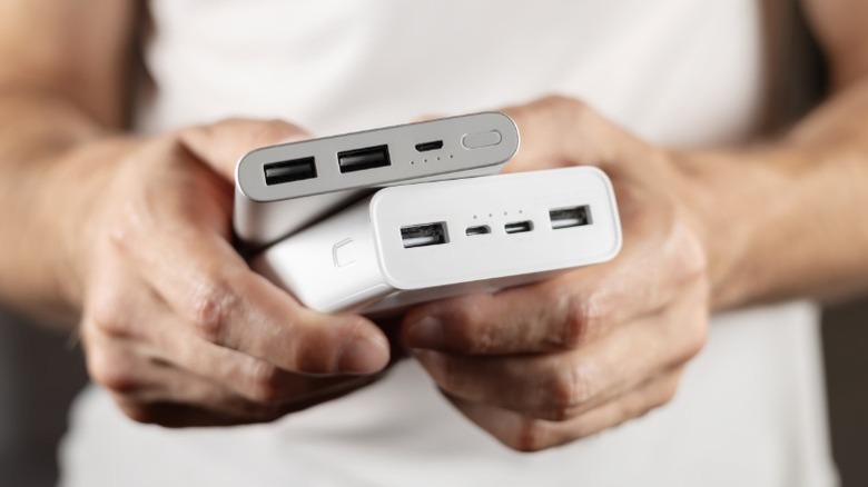 Person holding two power banks