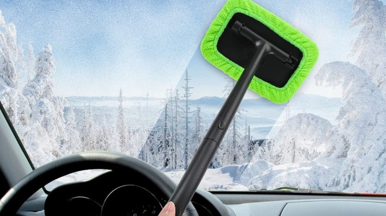 An extendable microfiber cleaning wand cleaning a windshield