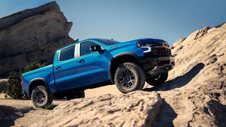Blue Chevy Silverado on rocky outcropping