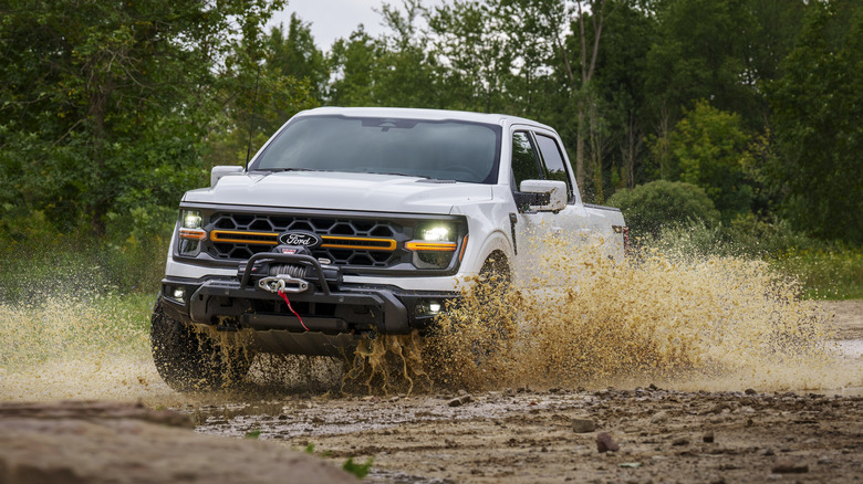 white Ford F-150 Tremor driving through mud puddle