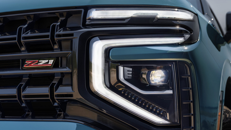 Close up of headlight and grille on blue 2026 Chevy Tahoe Z71