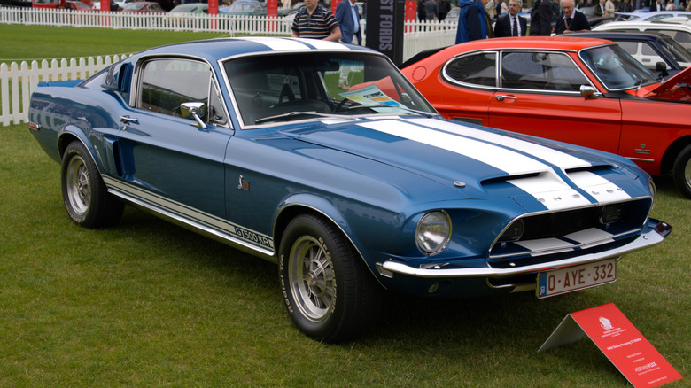 Blue and white 1968 Shelby GT500 KR parked on grass at car show