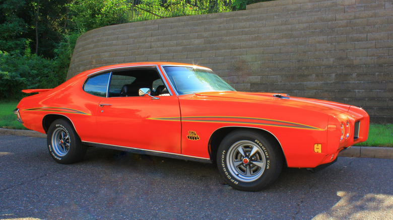 Orange 1970 Pontiac GTO Judge parked on road